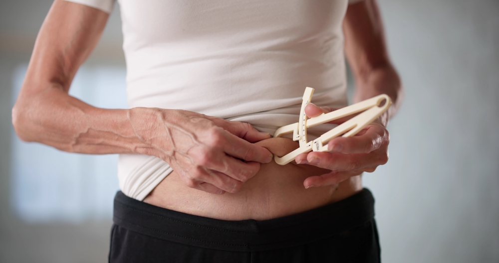 Female,Bariatric,Surgeon,Carefully,Measuring,Patient’s,Belly,Fat,With,Caliper.